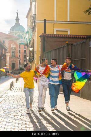 Couples of men having fun at the demonstration with the rainbow flags, gay pride party in the city, lgbt concept-stock-foto