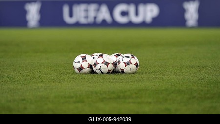 Footballs on a football field, in front of perimeter advertising with the logo of the UEFA-Cup-stock-foto
