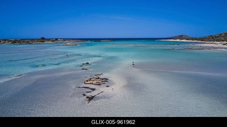 Clear sea water with stones and few people relaxing in the peaceful natural surroundings, Elafonissi, lagoon, south-west tip of Crete, Crete, Greek islands, Greece-stock-foto