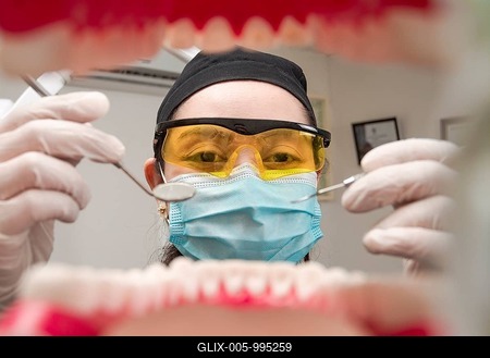 A dentist cleaning a mouth inside view, Inside view of a mouth checked by a dentist, a female dentist checking a patient. dentist checking a mouth, a dentist cleaning teeth-stock-foto