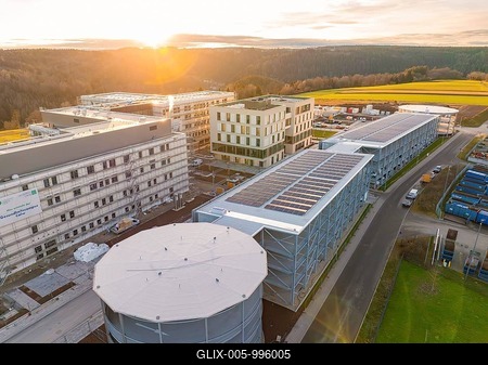 Large industrial complex with solar panels and surrounding nature at sunset, new Calw health campus, Calw district, Black Forest, Germany-stock-foto
