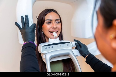 Dentist taking a dental x ray of a young woman in a modern dental clinic, ensuring accurate diagnostics for optimal treatment-stock-foto