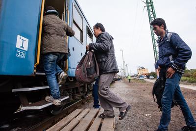 GYEKENYES- OCTOBER 6 : War refugees at the Gyekenyes Zakany Railway Station on 6 October 2015 in Gyekenyes, Hungary. Refugees are arriving constantly to Hungary on the way to Germany.-stock-photo