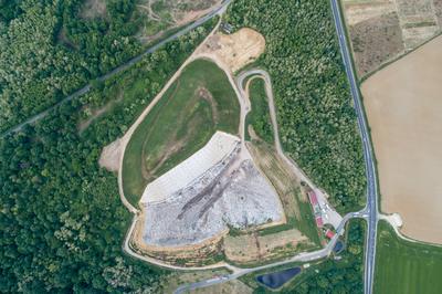 Garbage trucks unload garbage to a landfill, drone photo-stock-photo