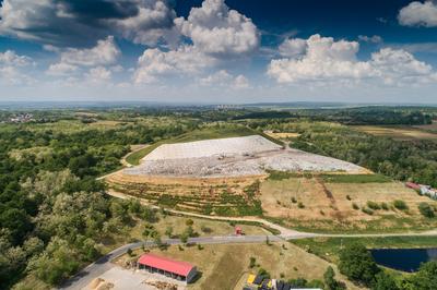 Garbage trucks unload garbage to a landfill, drone photo-stock-photo