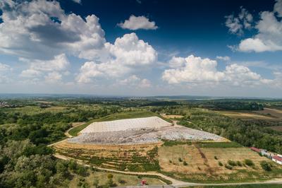 Garbage trucks unload garbage to a landfill, drone photo-stock-photo