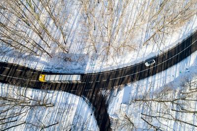 road with snowy forest in Hungary-stock-photo