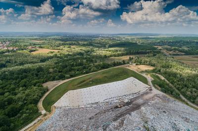 Garbage trucks unload garbage to a landfill, drone photo-stock-photo