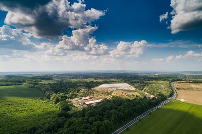 Garbage trucks unload garbage to a landfill, drone photo-stock-photo