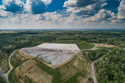 Garbage trucks unload garbage to a landfill, drone photo-stock-photo