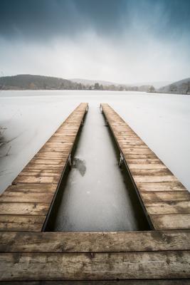 Frozen lake with wooden pier-stock-photo