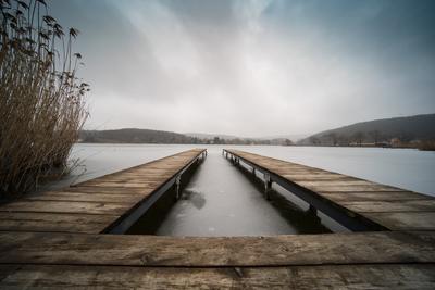 Frozen lake with wooden pier-stock-photo