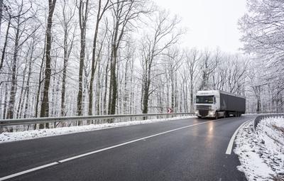 snowy road at cold wintertime with fast truck-stock-photo