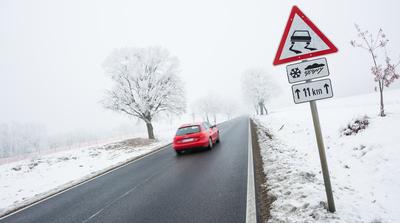 winter warning sign with snow-stock-photo