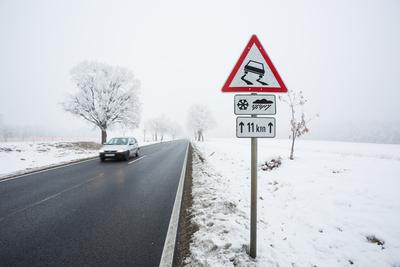 winter warning sign with snow-stock-photo