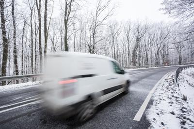 fast moving van with snowy road at cold wintertime-stock-foto