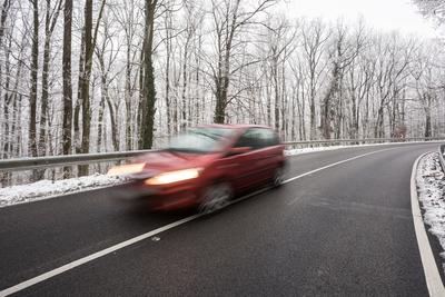 snowy road at cold wintertime-stock-photo