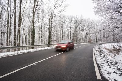 snowy road at cold wintertime-stock-photo