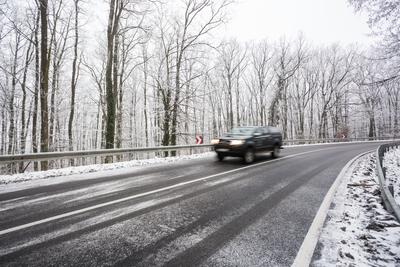 snowy road at cold wintertime-stock-photo