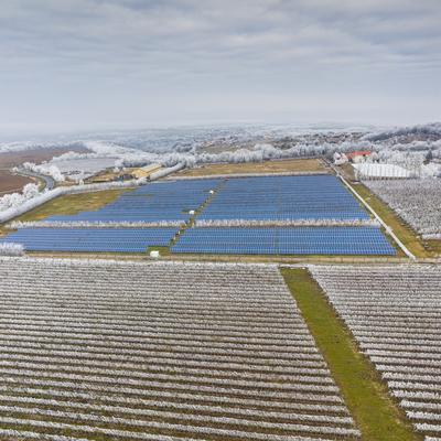 Winter frosty vineyard landscape covered by white flake with solar energy panels-stock-photo