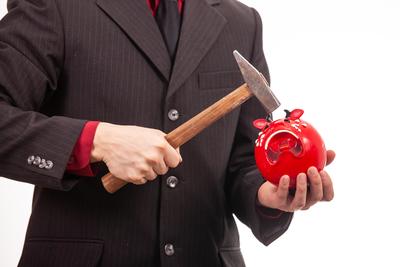 businessman break his red piggybank-stock-photo