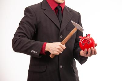 businessman break his red piggybank-stock-foto