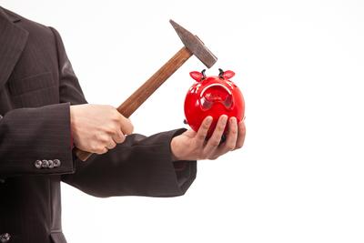 businessman break his red piggybank-stock-photo