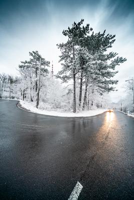 Snowy road with dramatic sky-stock-foto
