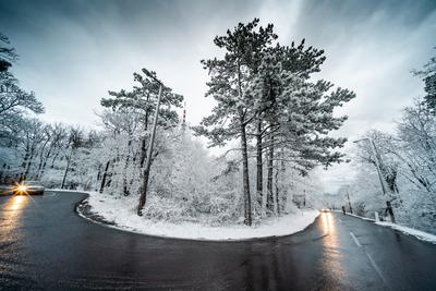 Snowy road with dramatic sky-stock-foto