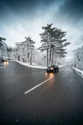 Snowy road with dramatic sky-stock-foto