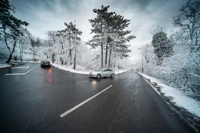 Snowy road with dramatic sky-stock-foto