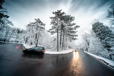 Snowy road with dramatic sky-stock-foto