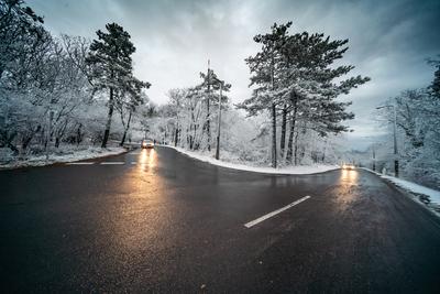 Snowy road with dramatic sky-stock-foto