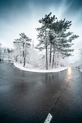 Snowy road with dramatic sky-stock-foto