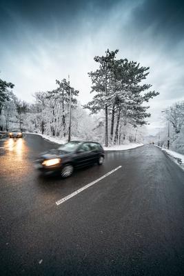 Snowy road with dramatic sky-stock-foto