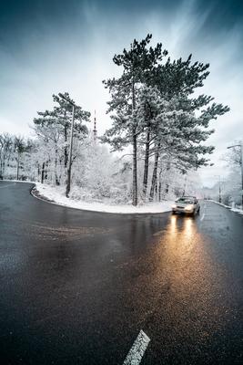 Snowy road with dramatic sky-stock-foto