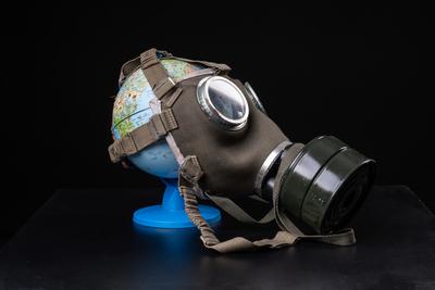 gas mask on a globe for coronavirus protection-stock-photo