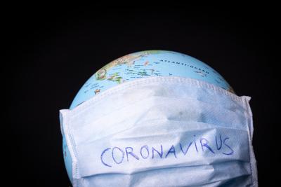 medical mask on a globe for coronavirus protection-stock-photo