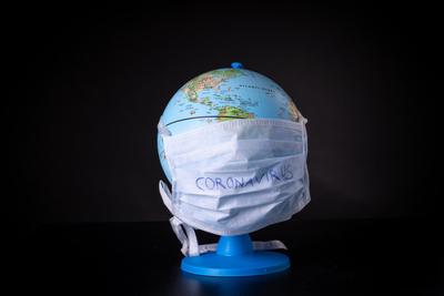 medical mask on a globe for coronavirus protection-stock-photo