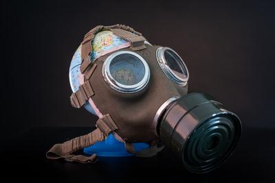 gas mask on a globe for coronavirus protection-stock-photo