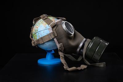 gas mask on a globe for coronavirus protection-stock-photo