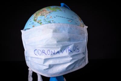 medical mask on a globe for coronavirus protection-stock-photo