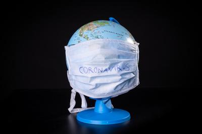 medical mask on a globe for coronavirus protection-stock-photo