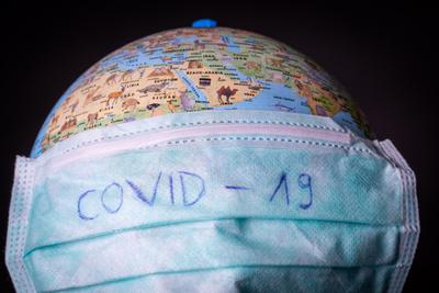 medical mask on a globe for coronavirus protection-stock-photo