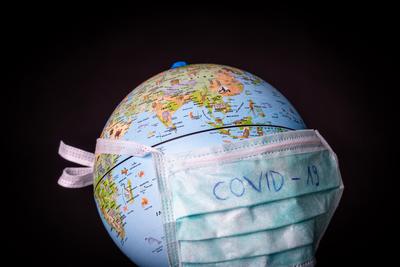 medical mask on a globe for coronavirus protection-stock-photo