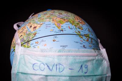 medical mask on a globe for coronavirus protection-stock-photo