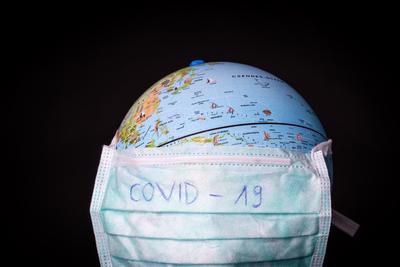medical mask on a globe for coronavirus protection-stock-photo
