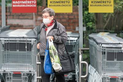 PECS - MAY 27 : Old woman go to shopping on the street  on 27 May 2020 in Pecs, Hungary. During coronavirus pandemic, everybody have to waering face mask-stock-photo