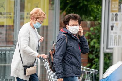 PECS - MAY 27 : Old woman go to shopping on the street  on 27 May 2020 in Pecs, Hungary. During coronavirus pandemic, everybody have to waering face mask-stock-photo