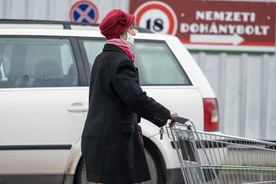 PECS - MAY 27 : Old woman go to shopping on the street  on 27 May 2020 in Pecs, Hungary. During coronavirus pandemic, everybody have to waering face mask-stock-photo